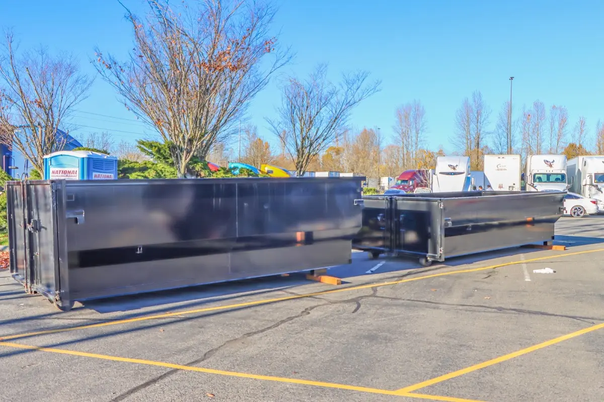 Professional dumpster rental service with roll-off container on residential driveway in Fort Campbell North